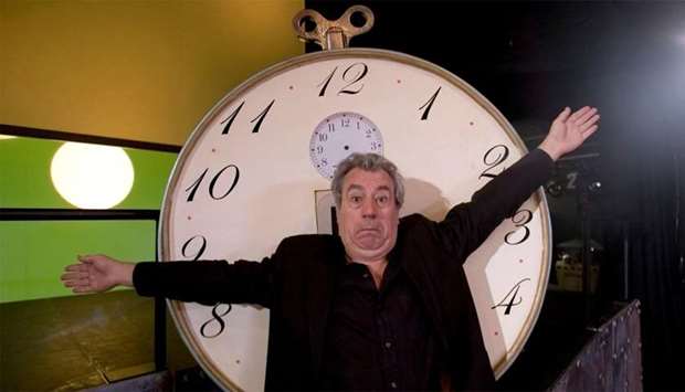 Former Monty Python star Jones gestures in front of ,time machine,