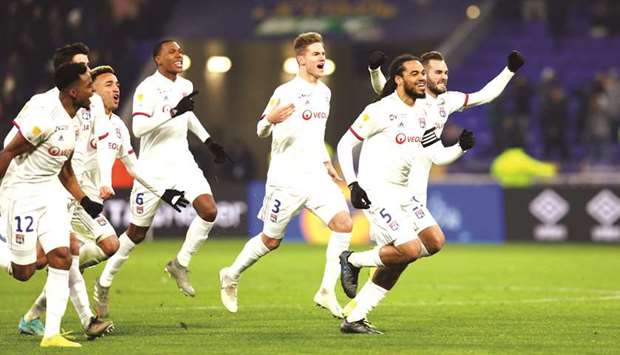 Lyon players celebrate after winning the penalty shootout. (Reuters)