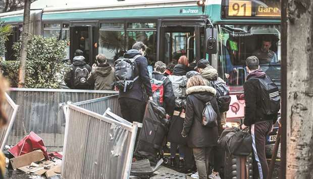 Commuters try to get on a bus outside Gare Montparnasse train station in Paris yesterday, on the 29th day of a nationwide multi-sector strike against the governmentu2019s pensions overhaul.