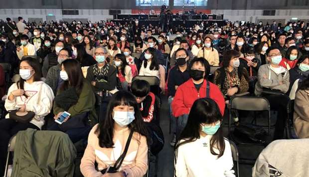 Foxconn employees wearing masks attend the company's year-end gala in Taipei, Taiwan