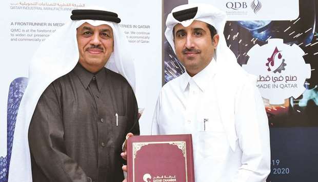 Qatar Chamber director-general Saleh bin Hamad al-Sharqi and QIMC CEO Abdul Rahman Abdulla al-Ansari exchanging agreements after the signing ceremony held in Doha yesterday.