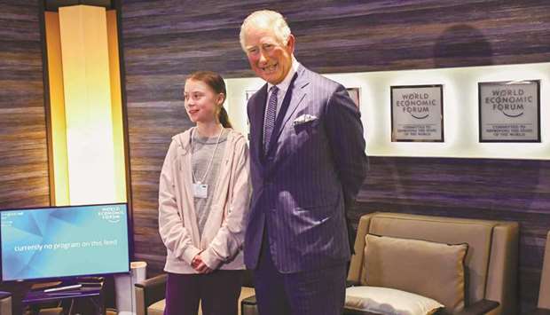 Charles, Prince of Wales, greeting Swedish climate activist Greta Thunberg at the World Economic Forum (WEF) annual meeting in Davos, yesterday.