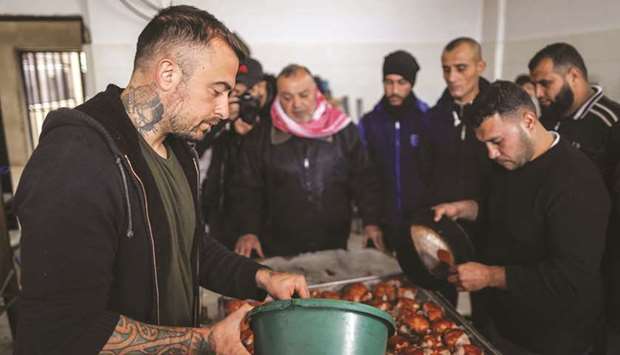 Gabriele Rubini (left), known as Chef Rubio, cooks with Palestinian prisoners at a Hamas-run civilian prison in Gaza City.