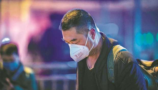 A man wearing a protective mask outside Beijing railway station yesterday.