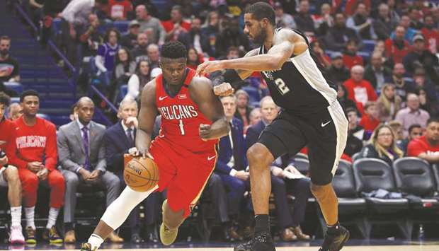 Zion Williamson (left) of the New Orleans Pelicans drives the ball around LaMarcus Aldridge of the San Antonio Spurs at Smoothie King Center on Wednesday. (AFP)