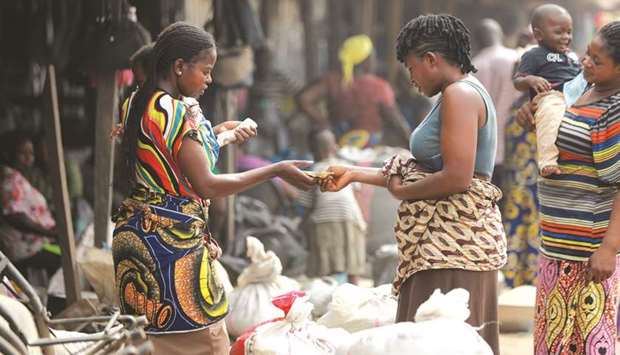 Women buy rice at Wurukum Rice Mill in Makurdi, Nigeria, in this December 2, 2019, photograph.