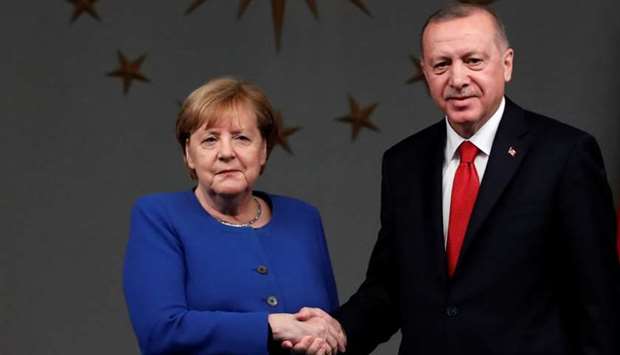Turkish President Tayyip Erdogan and German Chancellor Angela Merkel shake hands after a joint news conference in Istanbul