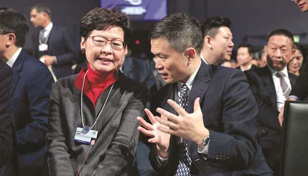 Carrie Lam, Hong Kongu2019s chief executive (left), speaks with Fang Xinghai, vice chairman of China Securities Regulatory Commission, on Tuesday. Lam has come under huge pressure as she struggled to end more than seven months of huge and often violent pro-democracy protests in Hong Kong, the most severe challenge to Beijingu2019s rule since the former British colonyu2019s 1997 handover to China.