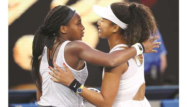 Coco Gauff of the US hugs Japanu2019s Naomi Osaka (R) after their womenu2019s singles match on day five of the Australian Open tennis tournament in Melbourne yesterday.