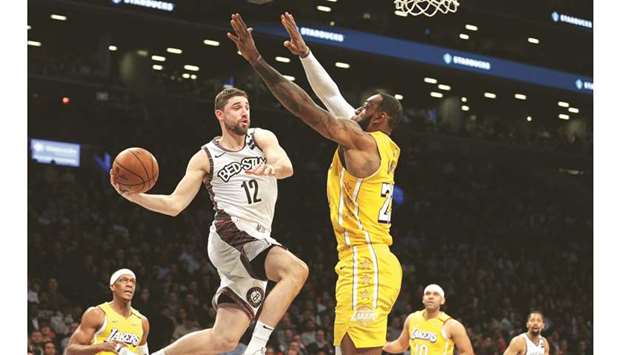 Los Angeles Lakersu2019 Devontae Cacok (left) passes the ball as Los Angeles Lakersu2019 LeBron James defends during the second half at Barclays Center. PICTURE: USA TODAY Sports