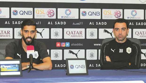 Al Sadd coach Xavi Hernandez (right) and midfielder Hassan al-Haydos address a press conference yesterday.