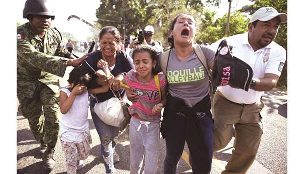 Members of the Mexican National Guard and officers of the Migration Institute detain Central American migrants in Ciudad Hidalgo, Chiapas state, Mexico.