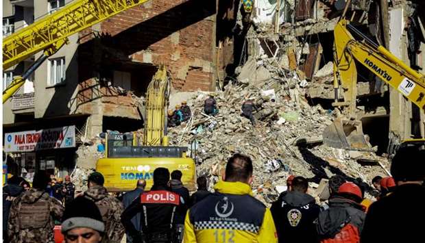 Rescue workers search for survivors in the rubble of a collapsed building after an earthquake hit Elazig, eastern Turkey