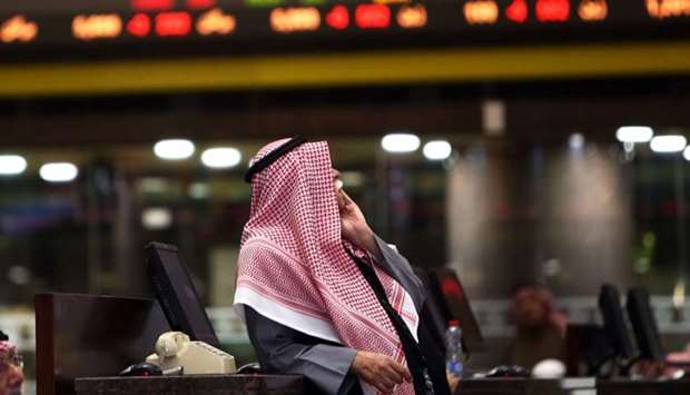 A Kuwaiti trader follows stock prices at Boursa Kuwait stock market in Kuwait City on January 6. Following Kuwait's MSCI upgrade scheduled for May 2020, it is also expected to post a higher P/E with increased fund inflows, Markaz Research has said.