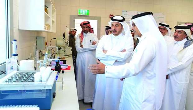HE the Prime Minister and Minister of Interior Sheikh Abdullah bin Nasser bin Khalifa al-Thani is briefed on the facilities at the aquatic research centre.