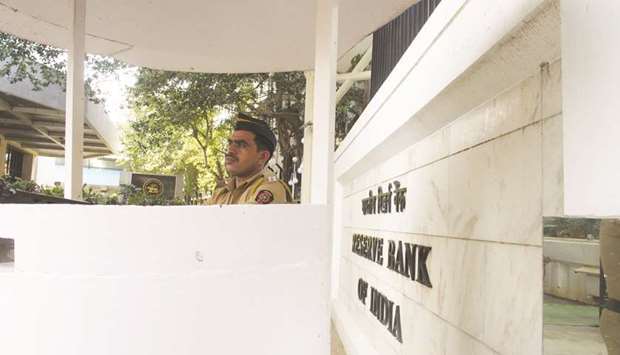 A police officer stands guard at the Reserve Bank of India headquarters in Mumbai. The RBI raised the cap to Rs1.5tn ($21bn) for foreign investors who voluntarily commit to keep a part of their investment in the country for at least three years, the RBI said in a statement late Thursday.