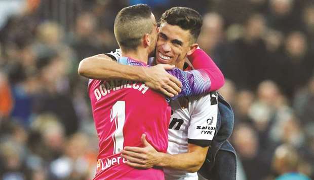 Valenciau2019s defender Gabriel Paulista (right) and goalkeeper Jaume Domenech celebrate after their win over Barcelona in the La Liga yesterday. (AFP)