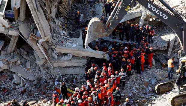 Rescue workers carry a body from the site of a collapsed building, after an earthquake in Elazig
