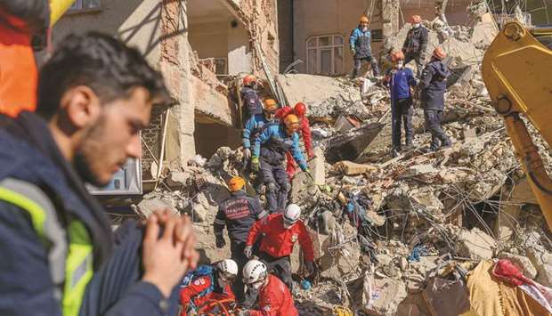 Rescue personnel work amid the rubble of a building in Elazig.