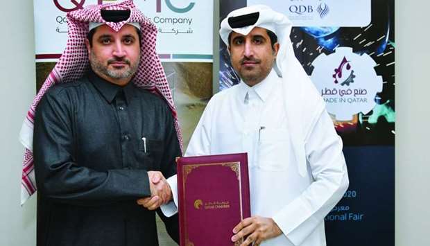 Qatar Chamber director general Saleh bin Hamad al-Sharqi and QPMC CEO Essa Mohamed Ali Kaldari shaking hands after signing the agreement.