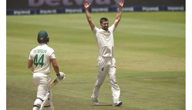 Englandu2019s Mark Wood (right) celebrates after the dismissal of South Africau2019s Dane Paterson during the third day of the fourth Test at the Wanderers Stadium in Johannesburg yesterday. (AFP)