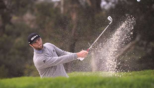 Spaniard Jon Rahm plays a shot from a bunker during the third round of the Farmers Insurance Open golf tournament in San Diego. (USA TODAY Sports)