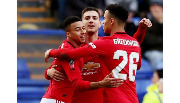 Manchester Unitedu2019s Jesse Lingard celebrates scoring their third goal with teammates Diogo Dalot and Mason Greenwood in FA Cup fourth round match against Tranmere Rovers at Prenton Park in Birkenhead, Britain, yesterday. (Reuters)