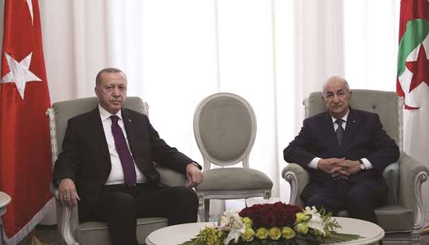 This handout picture taken and released yesterday shows Algerian President Abdelmadjid Tebboune meeting with Turkish President Recep Tayyip Erdogan in Algiers.