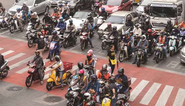 Motorcyclists and vehicles sit in traffic in Bangkok. Chinese holidaymakers u2014 many on group tours u2014 spent almost $18bn in Thailand last year, more than a quarter of all foreign tourism receipts, government data show. The industry as a whole contributes 21% to gross domestic product, according to the World Travel & Tourism Council.