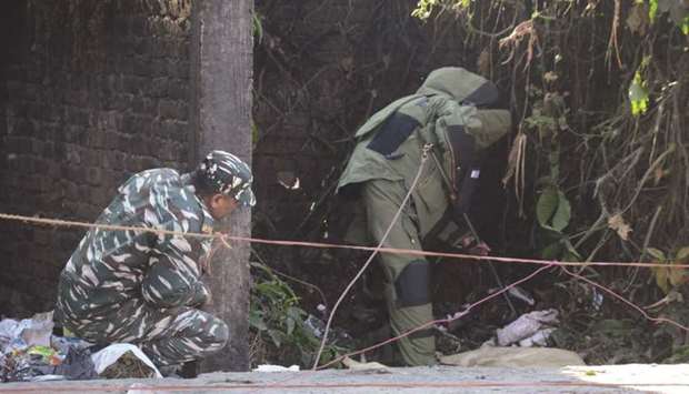 A member of the bomb disposal squad inspects the site where three low-intensity blasts took place in Dibrugarh district of Assam yesterday.