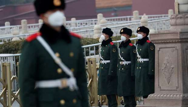 Paramilitary officers wearing face masks stand guard at the Tiananmen Gate, as the country is hit by an outbreak of the new coronavirus, in Beijing, China