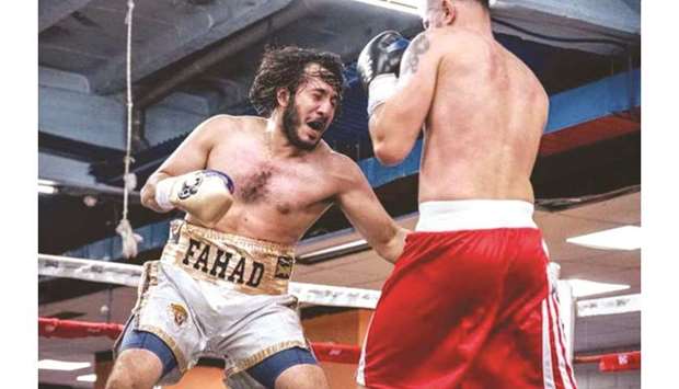 In this September 21, 2019, picture, Qatari boxer Sheikh Fahad bin Khalid al-Thani (left) lands a punch on Romaniau2019s Ionut Bogheanu during their bout in Madrid, Spain.