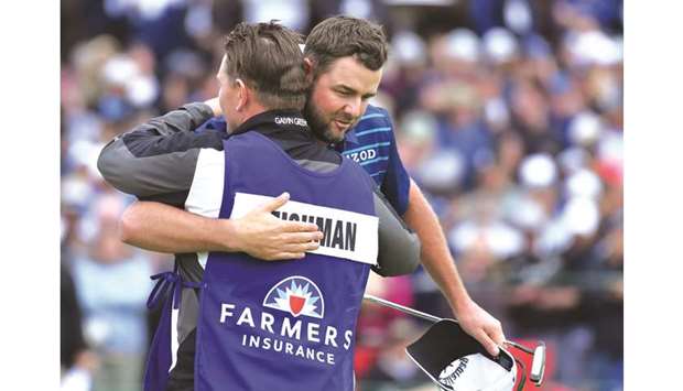 Marc Leishman of Australia hugs his caddie Matt Kelly after the putt on the 18th green during the final round of the Farmers Insurance Open at Torrey Pines South in San Diego, California, United States, on Sunday. (AFP)