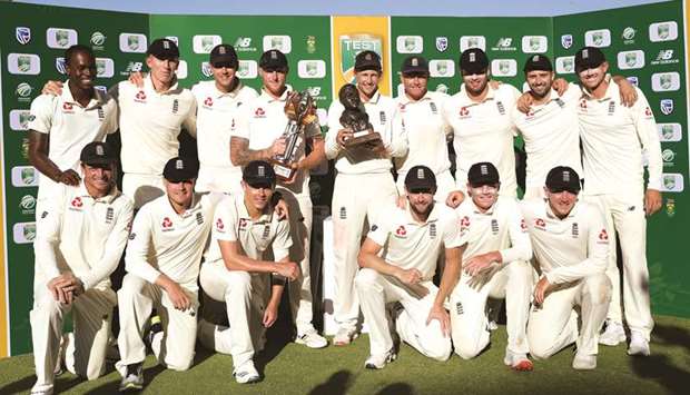 Englandu2019s captain Joe Root (back row centre) holds the series trophy with teammates at the end of the fourth day of the fourth Test in Johannesburg yesterday. (Reuters)