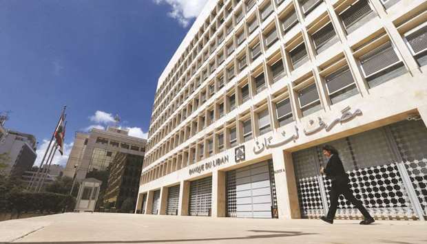 A woman walks outside of Lebanonu2019s central bank building in Beirut (file). The 2020 budget envisages a deficit of around 7% of GDP, the head of parliamentu2019s budget and finance committee, Ibrahim Kanaan, told Reuters, wider than the originally hoped-for 0.6% with the economy shrinking and choked by a liquidity crunch.
