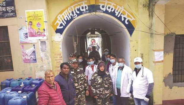 Members of a special team of the Health Ministry are seen at a border outpost along the Indo-Nepal border yesterday.