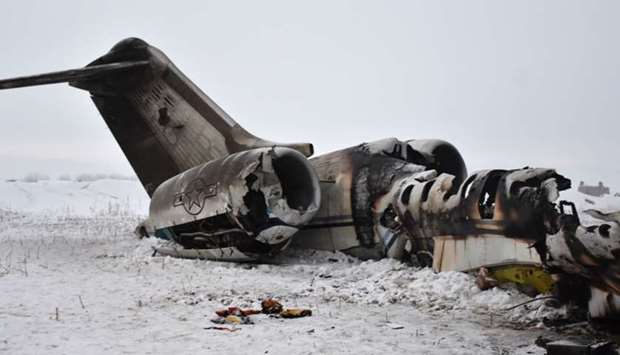 The wreckage of a US Bombardier E-11A jet is seen yesterday after it crashed in mountainous territory of Deh Yak district in Ghazni Province.