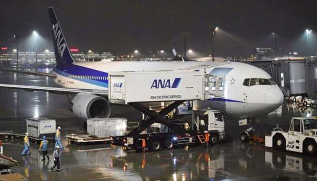 A charter plane bound for Wuhan, China, which is to evacuate Japanese nationals from the Chinese city, is seen at Haneda airport in Tokyo, Japan