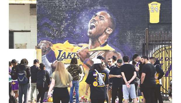 Fans gather to mourn the death of Kobe Bryant at a mural near Staples Center in Los Angeles, California on Monday. (AFP)