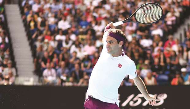 Switzerlandu2019s Roger Federer hits a return against Tennys Sandgren of the US during their quarter-final match on day nine of the Australian Open in Melbourne yesterday.