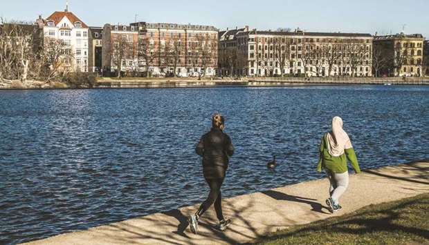 Joggers run along a footpath on the bank of a waterway opposite residential housing in Copenhagen. The Danish Financial Supervisory Authority is now telling lenders they shouldnu2019t meet the balance principle through the routine use of derivatives. Kristian Vie Madsen, the deputy director for banks at the FSA in Copenhagen, says using derivatives like interest-rate and currency swaps to meet the requirement u201cshould not be the normal way of doing things.u201d