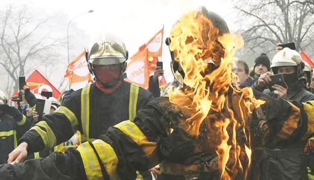 A firefighter sets a colleague on fire during a demonstration in Paris against the French governmentu2019s plan to overhaul the countryu2019s retirement system.