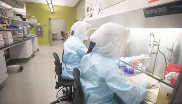 Scientists work in VIDO-InterVac's (Vaccine and Infectious Disease Organization-International Vaccine Centre) containment level 3 laboratory, where the organization is currently researching a vaccine for novel coronavirus, at the University of Saskatchewan in Saskatoon, Saskatchewan, Canada October 18, 2019