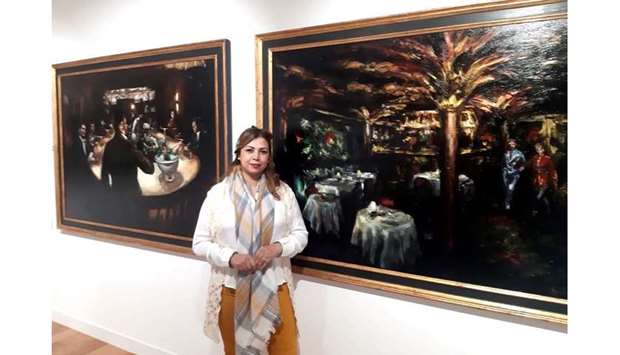 EXHIBITION: Soumaya Akbib standing in front of the works of Tomas Baletzena.