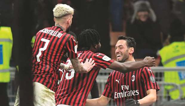 AC Milanu2019s Hakan Calhanoglu (right) celebrates with teammates after scoring in the Italian Cup match against Torino in Milan on Tuesday night. (AFP)