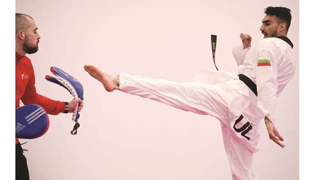 Iranian taekwondo competitor Farzad Zolghadri practices with Bulgarian national taekwondo team coach Teodor Georgiev during a training session in Sofia, Bulgaria, yesterday. (Reuters)