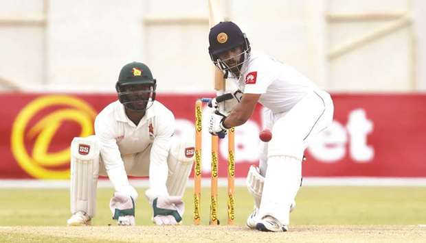Sri Lankau2019s Kusal Mendis (R) plays a shot as Zimbabweu2019s Regis Chakabva (L) looks during the fifth day of the second Test match at the Harare Sports Club yesterday.