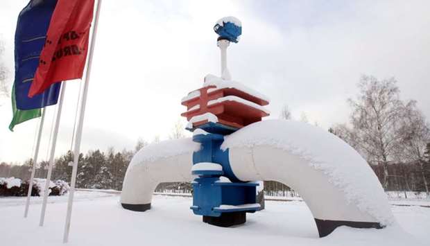 A model of a pipe line is seen at the main entrance to the Gomel Transneft oil pumping station, which moves crude through the Druzhba pipeline westwards to Europe, near Mozyr some 300 km (186.3 miles) southeast of Minsk January 8, 2010