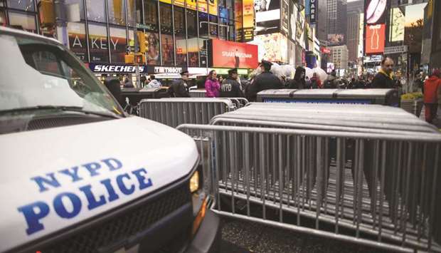 NYPD officers stand guard at Times Square yesterday in New York City. The NYPD will take actions to protect the city and residents against any possible retaliation after the deadly US airstrike in Iraq, Mayor Bill de Blasio said during a press conference yesterday.