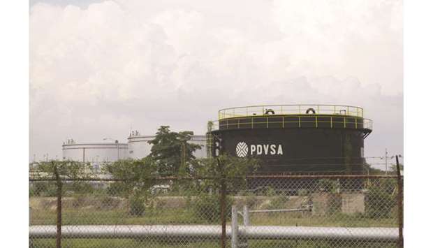 Tanks with the logo of the PDVSA are seen in Cabimas, Venezuela. PDVSA is letting some joint venture partners take over the day-to-day operation of oilfields as its own  capacity dwindles due to sanctions and a lack of cash and staff, according to a former oil minister, an opposition lawmaker and industry sources.